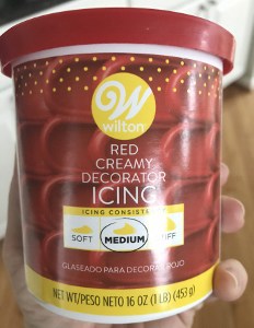 Can of Wilton's red decorator frosting to use for Elmo's fur