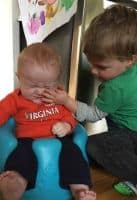 toddler slapping his new baby brother