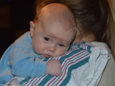 mom holding one month old baby