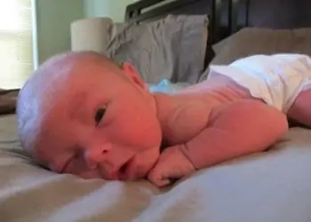 a brand new baby struggling with tummy time