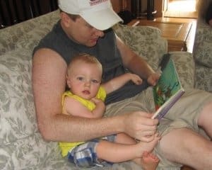 dad doing daily reading activity with his toddler