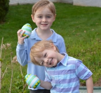 Two kids with Easter eggs filled without candy