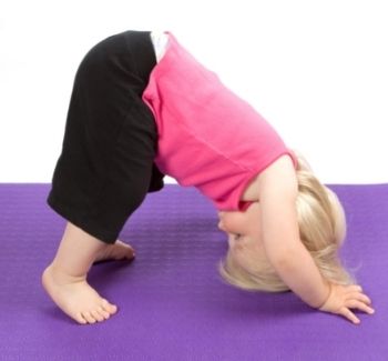 toddler doing downward facing dog yoga pose