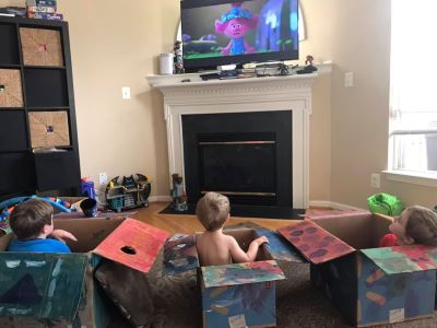 Kids playing with household boxes as toys